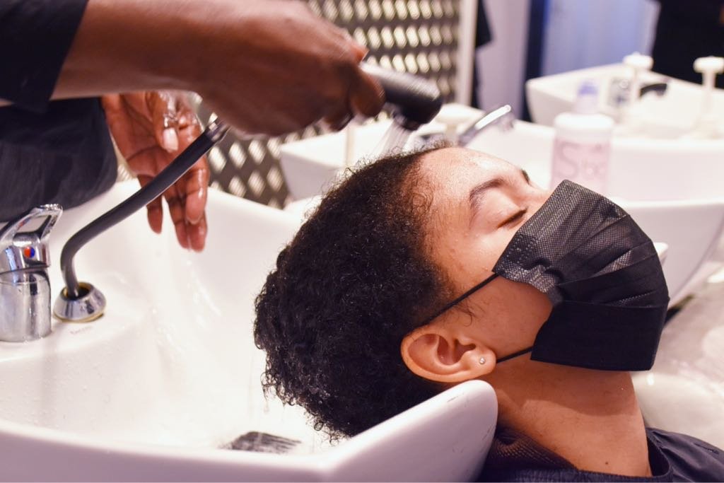mixed-race-young-woman-getting-hair-washed-at-hair-2025-02-11-15-27-07-utc_Medium